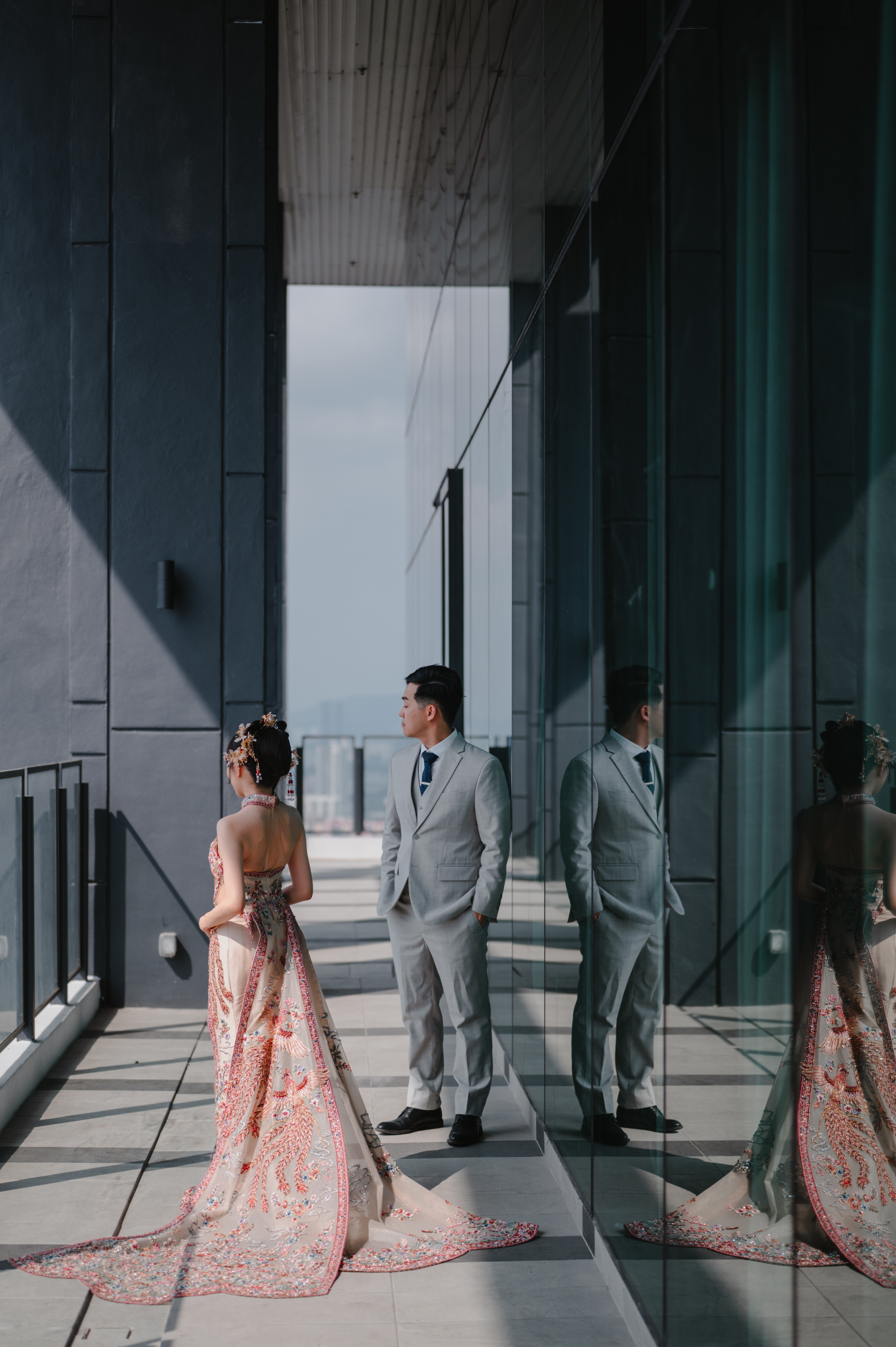 Couple at floral arch during sunset wedding ceremony KL