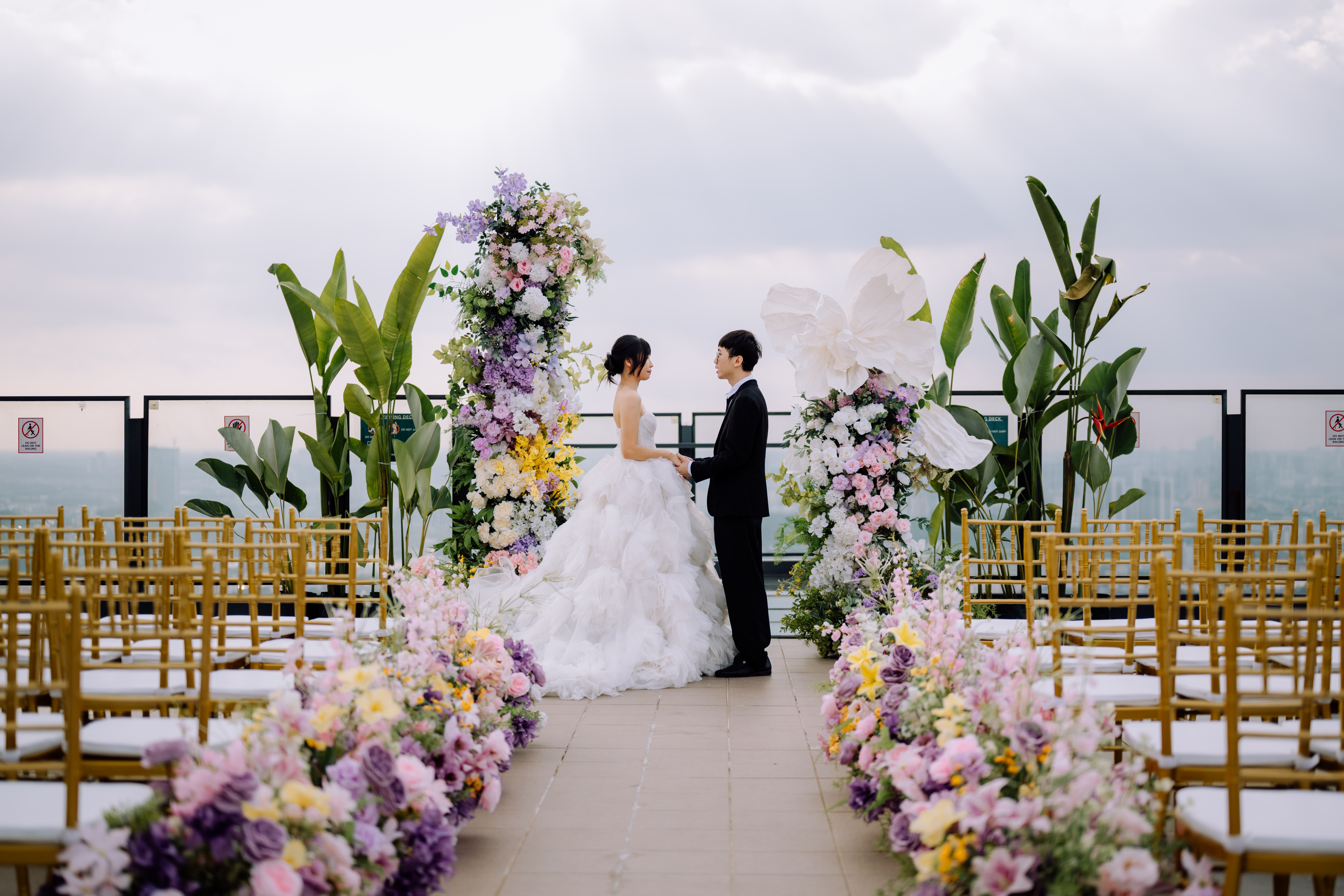Couple at W. in the Sky ROM ceremony with city view